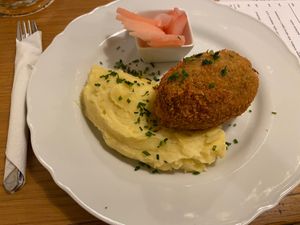 Ground seitan schnitzel filled with vegan cheese at Moment in Prague