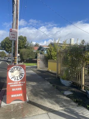 Street Signage Near Outdoor Patio Area  at Nick's Pizza in Oakland