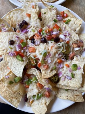 Vegan Nachos: organic corn chips, onions, tomatoes, peppers, jalapenos, olives, salsa & Daiya cheese   at The Wooden Monkey in Halifax