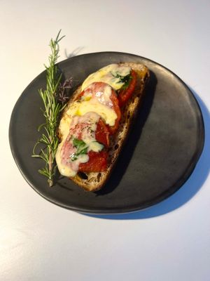 Open toast tomatoes and mozzarella cheese  at A QUE TE SABE in Oaxaca