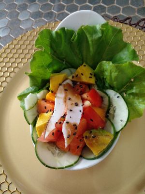 Salad: lettuce, cucumber, coconut, papaya, tomato, mango, avocado, sesame seed and balsamic dressing. at Love Thyself Vegan Kitchen in St Georges