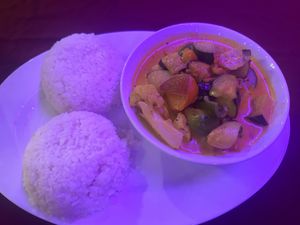 Coconut veggie curry with rice. Normally comes with garlic bread and coleslaw, but just asked for double rice instead    at Enjoy Lounge & Restaurant in Caye Caulker