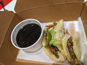 2 impossible taco plate with double black beans and two bites out of it. at Taco Cantina in San Francisco