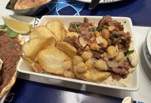 Hummus with meat and fries  at Al Safadi in Abu Dhabi