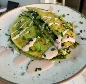 Pea crepes with fermented dried fruit cheese, fermented red onion, seasonal vegetables at Baak Libreria Bistrot in Bologna