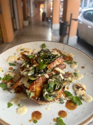 Crostone with Oyster mushrooms, veg bechamel and seasonal vegetables with miso at Baak Libreria Bistrot in Bologna