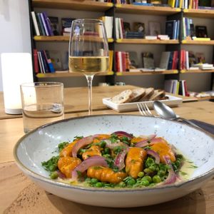 Sweet Potato Gnocchi with Marinated Red Onions and Peas on Rosemary Chickpea Milk at Baak Libreria Bistrot in Bologna