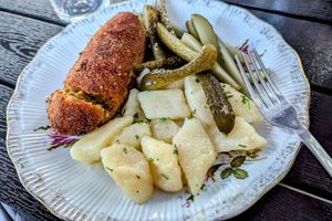 Kiev style "Chicken" cutlet with potato dumplings and pickled cucumbers at Vegan Friends Kitchen in Warsaw