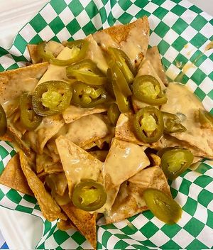 Friday Night Lights Nachos
on trailer-made tortilla chips, nacho cheeze and pickled jalapeños. These are a classic that remind us of Texas football, concession stand-type nachos. at That Weird Place in Amarillo