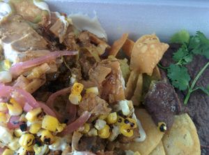 Chilaquiles : smoked,  pulled jackfruit sauteed with housemade salsa verde, poblano peppers, red onion & spinach, served over crispy housemade corn chips with cashew ‘crema’, red onion and roasted corn and creamy black beans   at Verdine - Food Truck in Houston