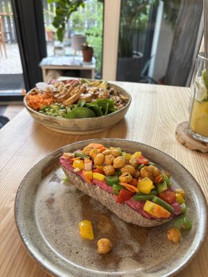 At the back the tofu Buddha bowl, and at the front the chickpea and roast veg on beetroot hummus, on toastt  at Daržo Dubuo in Vilnius