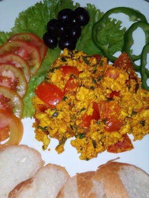 Tofu scramble with fresh veggies, olives and baguette in Bamboo Bar & Vegetarian Restaurant at Bamboo Bar & Vegetarian Restaurant in Sihanoukville