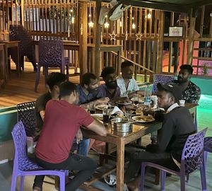 The team enjoy dinner at the end of service at Banana Leaf Restaurant Kovalam in Kovalam