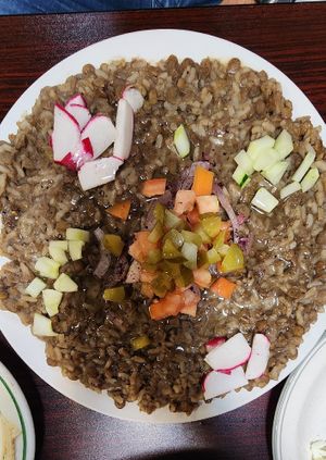 Mujaddar plate with extra veggies on top at Cedars Mediterranean Cuisine in Mcmurray