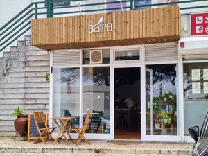 Entrance and external chairs at Saíra Café in Cascais