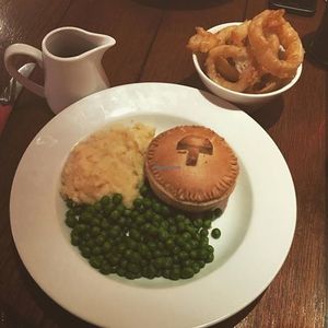Vegan chestnut mushroom and ale pie with vegan mash potatoes, pea, vegan onions rings with vegan gravy! at The Lady Luck in Canterbury