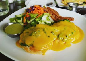 Vegan Daily Benny at Wild Leek...English muffin, eggy patty, sauteed greens, and Hollandaise sauce, served with salad. Also, an added side of their super tasty seitan bacon. Breakfast is served everyday until 4pm and comes with a free cup of coffee. at Wild Leek in Halifax