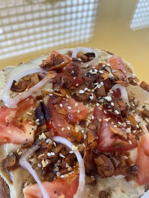 Hummus Toast, homemade sourdough, hummus, tomato, shallots, coconut bacun,everything seasoning, balsamic glaze   at Nourish Wellness Cafe - Pop Life  in Cleveland