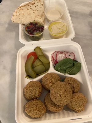 Jamal Falafel Middag Special - 7 huge homemade falafel, creamy hummus, smoky baba ganoush, tahini dressing, warm pita, pickles and fresh veggies   at Jamal's Falafel in Oslo