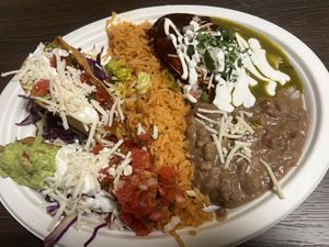 Combo plate #3 crispy potato taco, chicken taquito, enchilada green/red  at El Cantaro Vegan Mexican Restaurant in Monterey