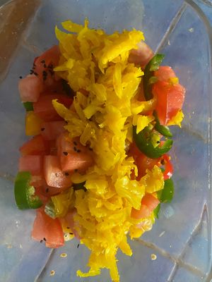 Yellow orange red peppers, tomatoes, jalapeño, Mandarine, tumeric ginger sauerkraut with black sesame seeds  at Suka Kitchen Culebra  in Culebra