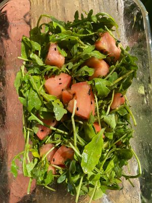 Arugula tomato salad with coconut almond ginger dressing and black sesame 

And a side of curry cashews
(Good alone or on the salad)  at Suka Kitchen Culebra  in Culebra