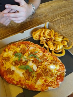 This is the vegan fet- ISH pizza which came with curly fries for £10 .it was very tasty. at The Northern Market in Leeds