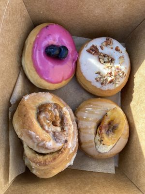 Blueberry sage, maple pecan, bananas foster, sweet potato cinnamon roll  at Cloudy Donut Co - NoLita in New York City