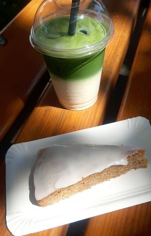Iced matcha latte and vegan carrot cake to go at Aufzug Café in Vienna