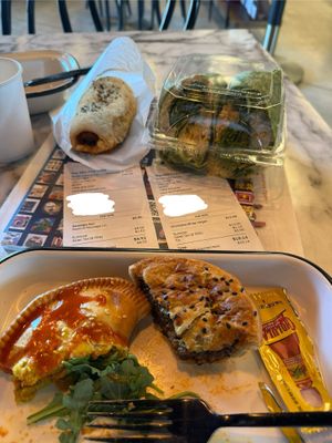 Unique veg options! Clockwise: Beyond protein sausage roll, chickpea wrap, Beyond protein aussie meat pie, curry pie. They also have avocado toast and to-go salads, hummus, etc. at The Dez Fine Food in Joshua Tree