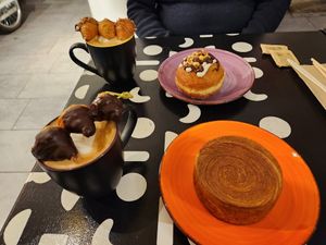 Vegan croissant, nutella and cream cheesecake bombolone (vegan). Latte comes with these super cute mini croissant! The dark chocolate ones are vegan. at Unregular Bakery in New York City
