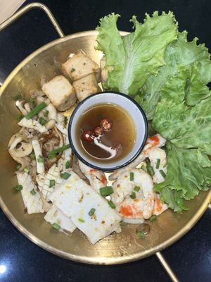 Butter grilled seafood platter with vegan squid, shrimp, tofu and mushrooms.   at Kem-Kon Pahurat (เข้ม-ข้น พาหุรัด) in Bangkok