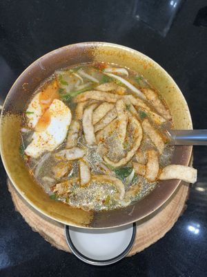 Sukothai tom yum noodles with plant-based pork, meatballs and eggs.  at Kem-Kon Pahurat (เข้ม-ข้น พาหุรัด) in Bangkok