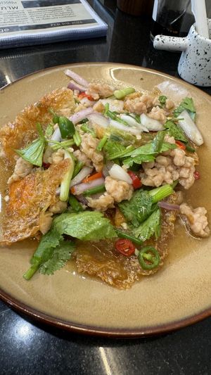 Fried “egg” spicy salad  at Kem-Kon Pahurat (เข้ม-ข้น พาหุรัด) in Bangkok