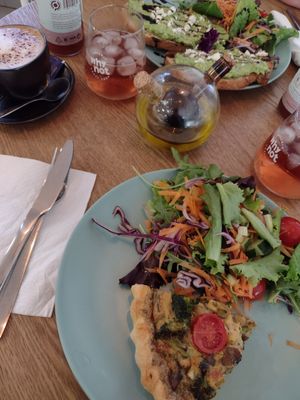 Quiche with free side salad (bottom) and smashed Avocado on self-made sourdough bread. Local Limonade and a cappuccino made in heaven. at The Garden Bakery - Online in Portimao