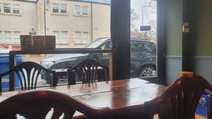 Wooden tables and the view through the front window of the cafe at The Kitchen Treasury in Kirkcaldy