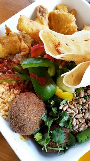 Bhima bowl with falafel, papadam, pakora and millet at Goura Pakora in Berlin