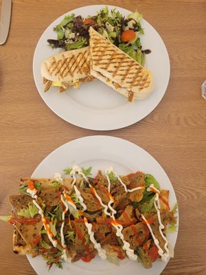 Philly Beefsteak Panini and Seitan Kebab Served on Pitta Bread with Salad at Pip & Oat in Llandudno