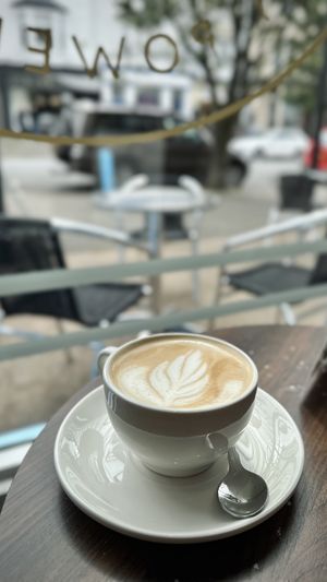 Latte by the window  at Pip & Oat in Llandudno