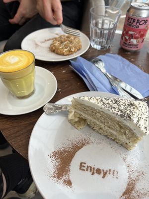 Turmeric latte with cakes and cookies.   at Pip & Oat in Llandudno