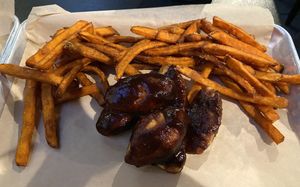 Vegan wings with bbq sauce and sweet potato fries   at Boodas Brewing Company  in Hendersonville