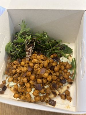 Warm chickpea flatbread to go  at Alma's Ethical Cakes & Bakes in Hebden Bridge