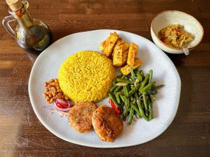 Yellow rice, long beans, tofu, potato fritters  at Taste of Bali in Timisoara