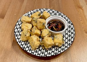 Tofu (soy) tempura, wheat flour, with kaffir lime leaves and green onions. Served with sweet soy sauce, with garlic, shallots, limes and a little hot pepper. at Taste of Bali in Timisoara