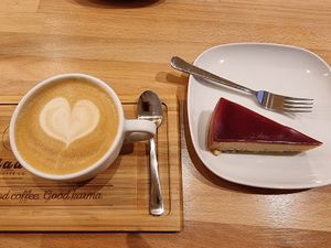 Plant-milk cappuccino and vegan cheesecake at Madal Cafe in Budapest