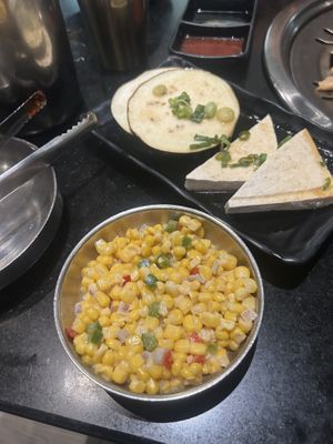 Corn salad with marinated eggplant and tofu bulgogi in back at Master Kim's Korean BBQ  in Las Vegas