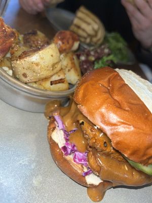 Satay tofu burger, potatoes and salad  at Vegivores  in Bournemouth