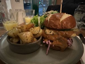Satay slay burger with potatoes   at Vegivores  in Bournemouth