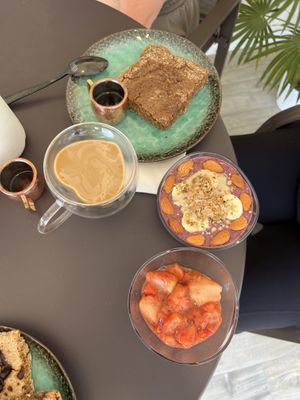 Smoothie bowl and heart shaped coffee with an almond butter pancake   at Akasha Metaphysical & Vegan Cafe in St Georges