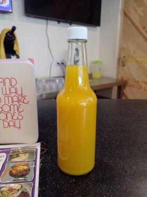 Liquid Sunshine (orange, pineapple, lemon, ginger, tumeric) at Akasha Metaphysical & Vegan Cafe in St Georges